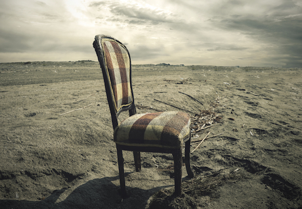 Wooden chair alone on Sand