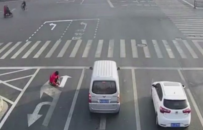 Chinese-man-repainting-road